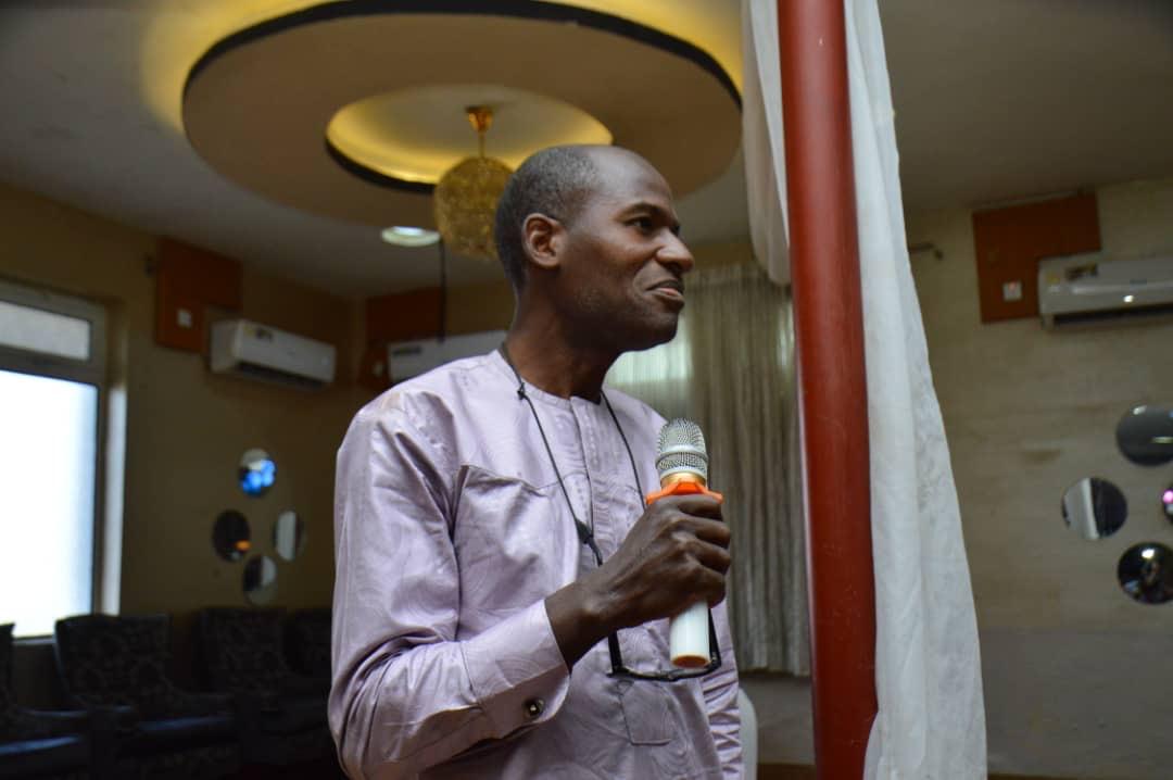 Abimbola sharing the Word with a microphone